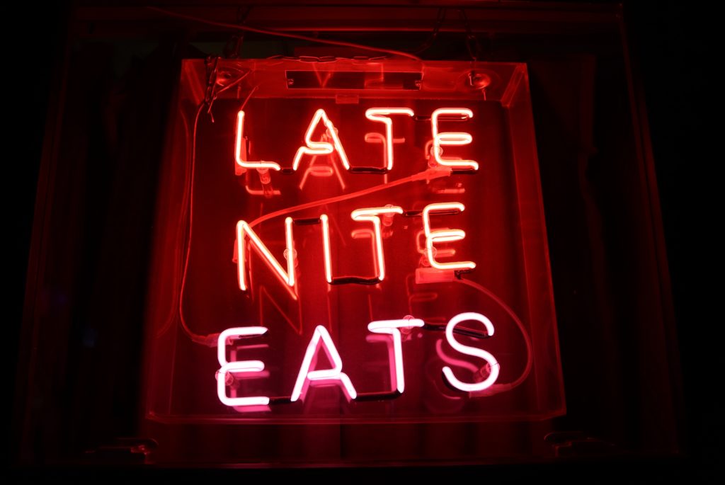 Late NITE EATS written with glowing letters. Appears as a Name of a restaurant on a nightly background