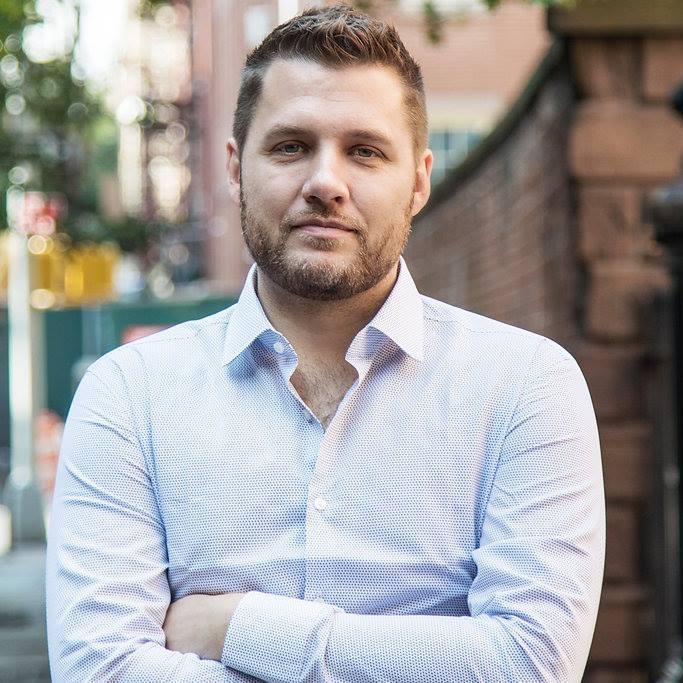 everything is f*cked author in bright blue buttoned shirt