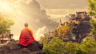 Meditation Benefits. A monk sitting on a cliff with his back to the camera on the background there is sunshine, temple and forest